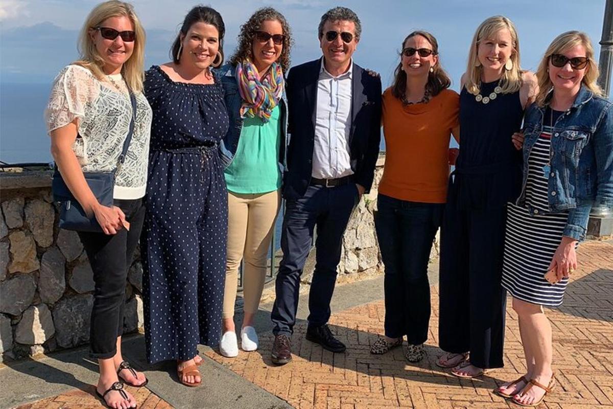 um grupo de pessoas posando para uma foto na parede
