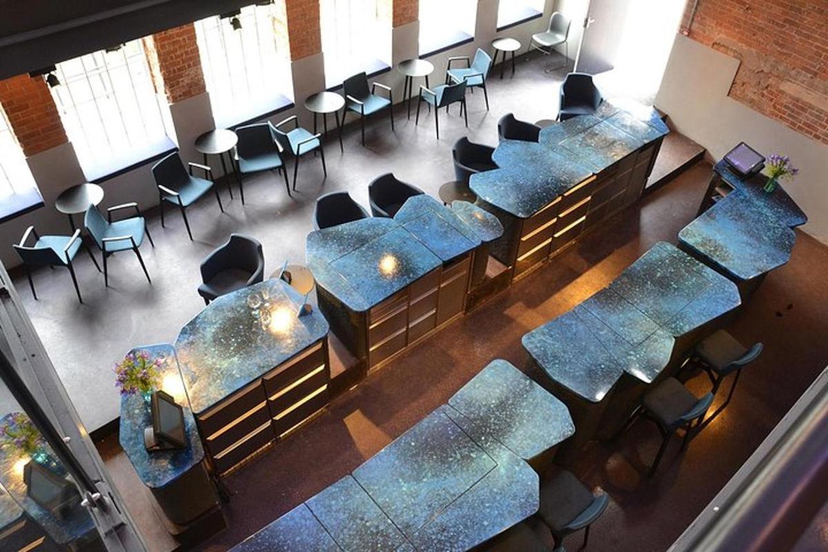an overhead view of a waiting room with blue tables and chairs