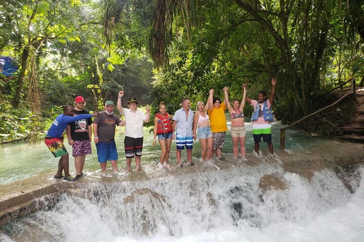 un gruppo di persone in piedi in cima a una cascata