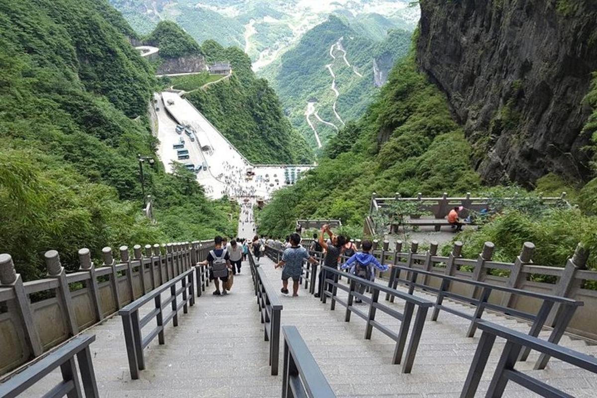 a group of people walking down a mountain road