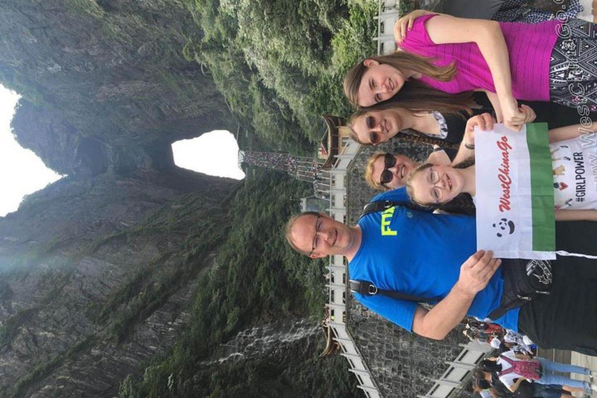 a group of people posing for a picture under a bridge