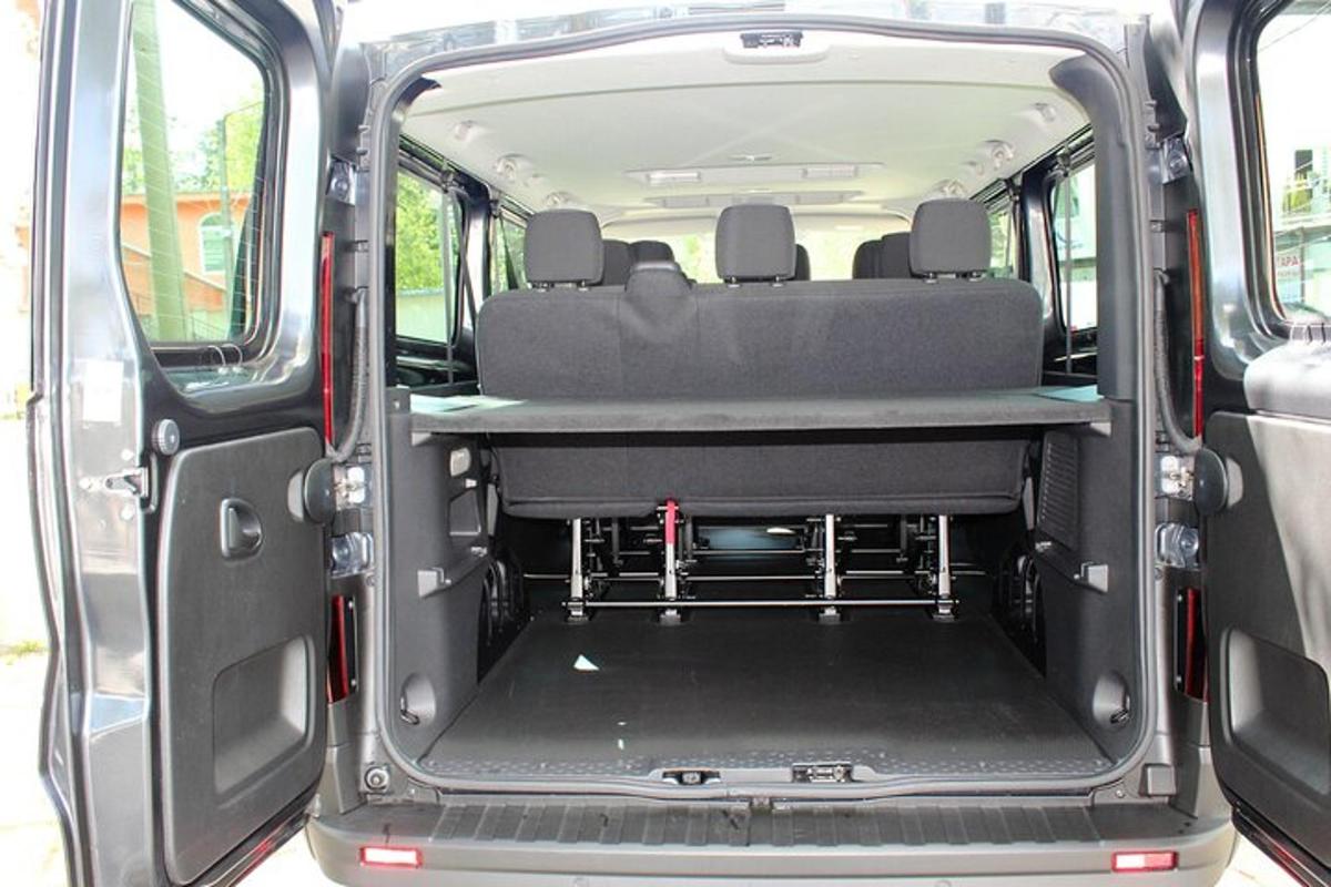 an open trunk of a van with the back door open