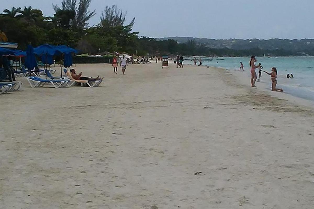 sekelompok orang berjalan di pantai