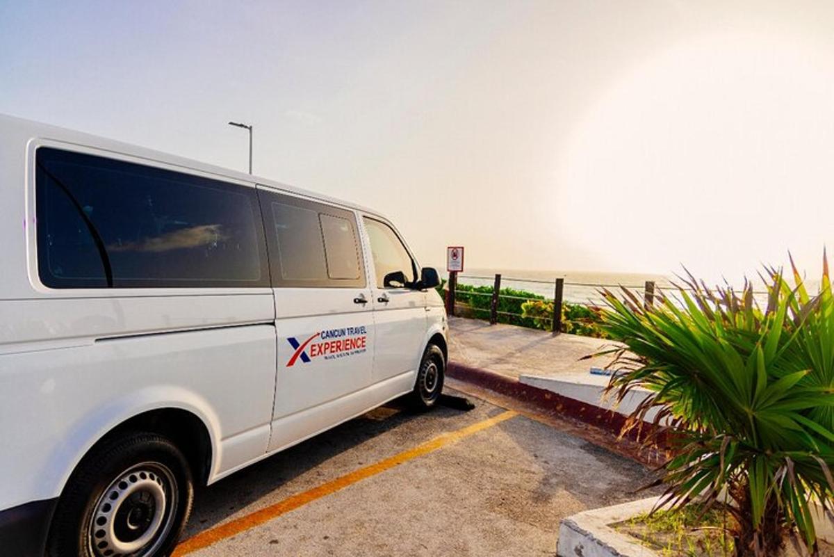 a white van parked in a parking lot near the ocean