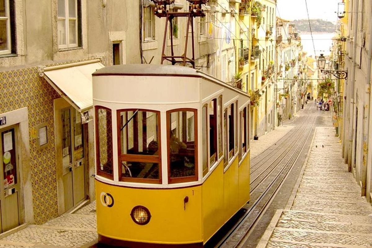a yellow and white tram on a city street
