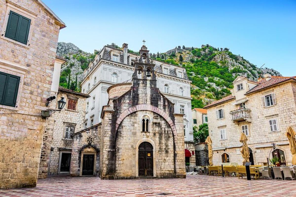un vecchio edificio in una città con una montagna sullo sfondo