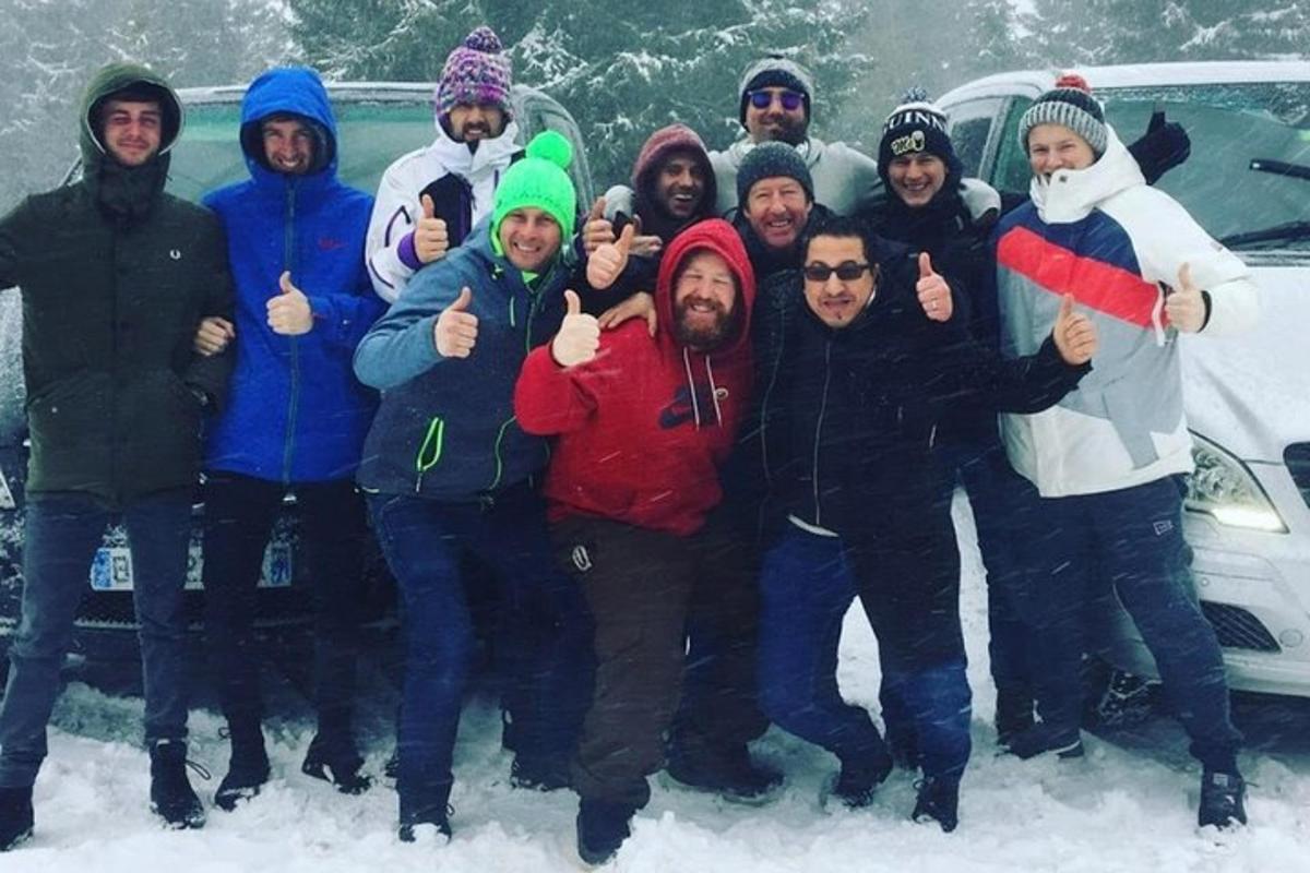 a group of people posing for a picture in the snow