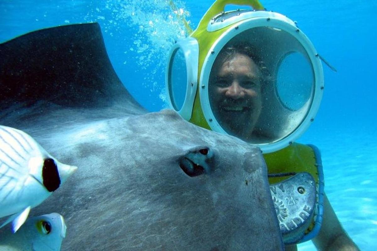 a man in the water next to a fish