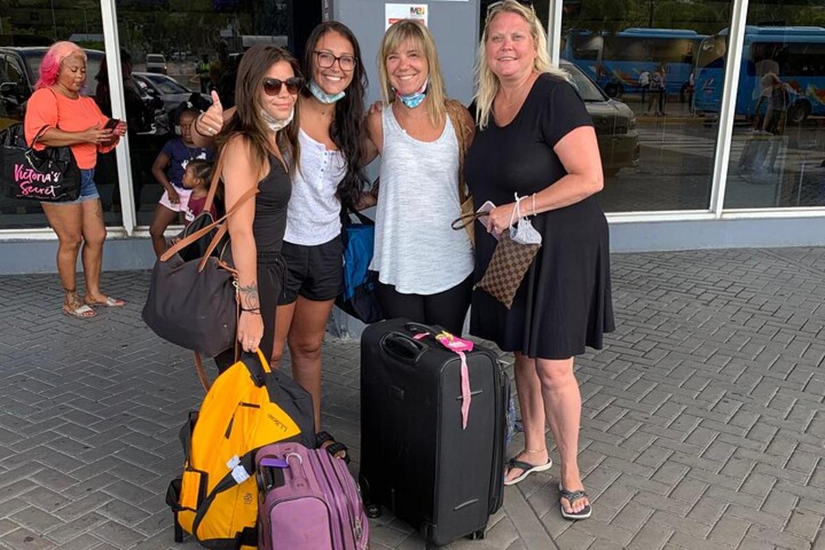 Cuatro mujeres posando para una foto con su equipaje