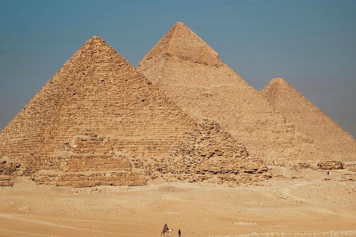 Un grupo de pirámides en el desierto bajo un cielo azul.