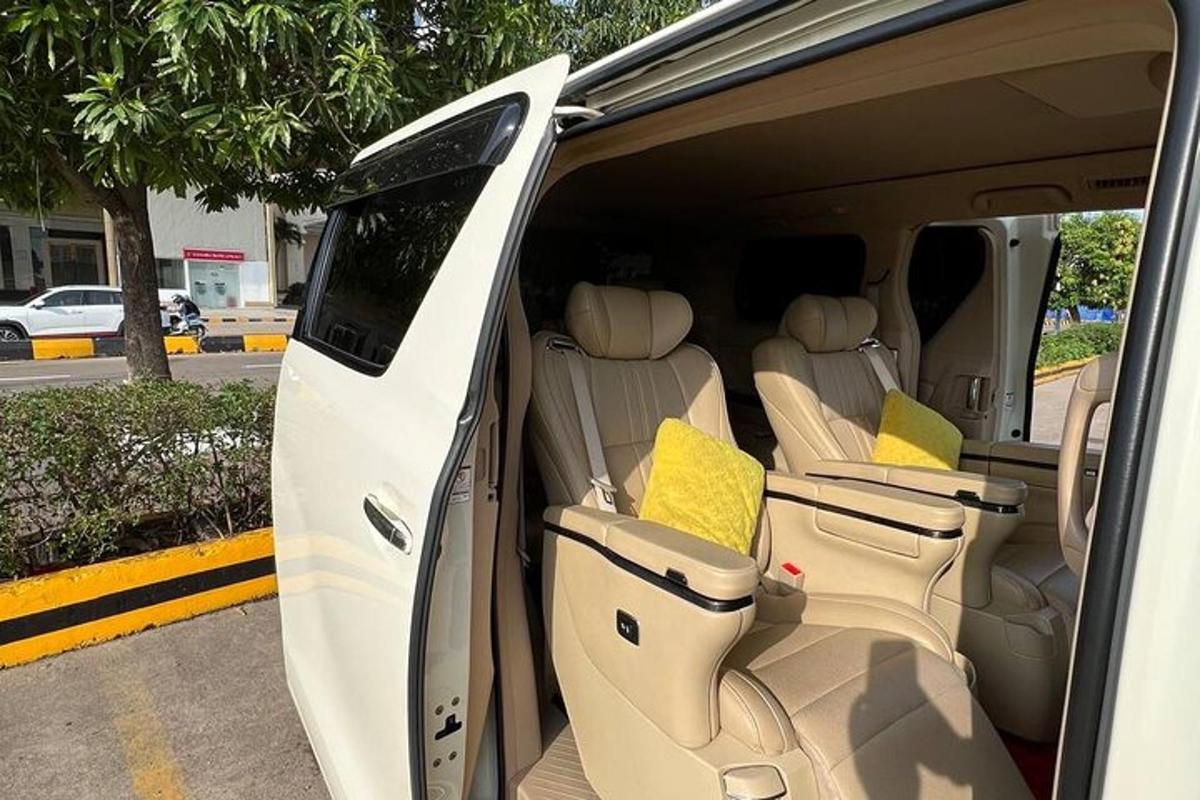 a white van with its doors open with yellow pillows