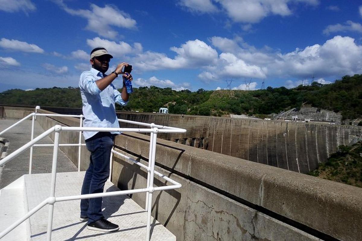 a man standing on a bridge taking a picture