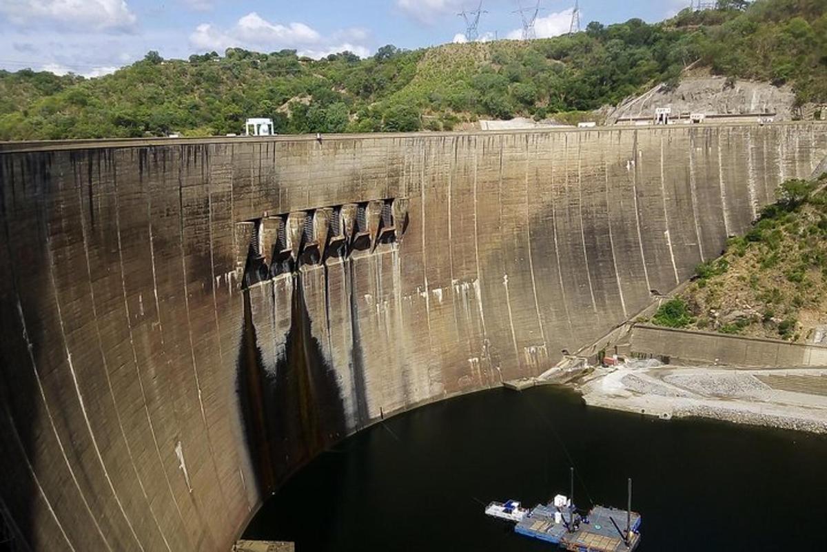 a boat is docked in front of a dam