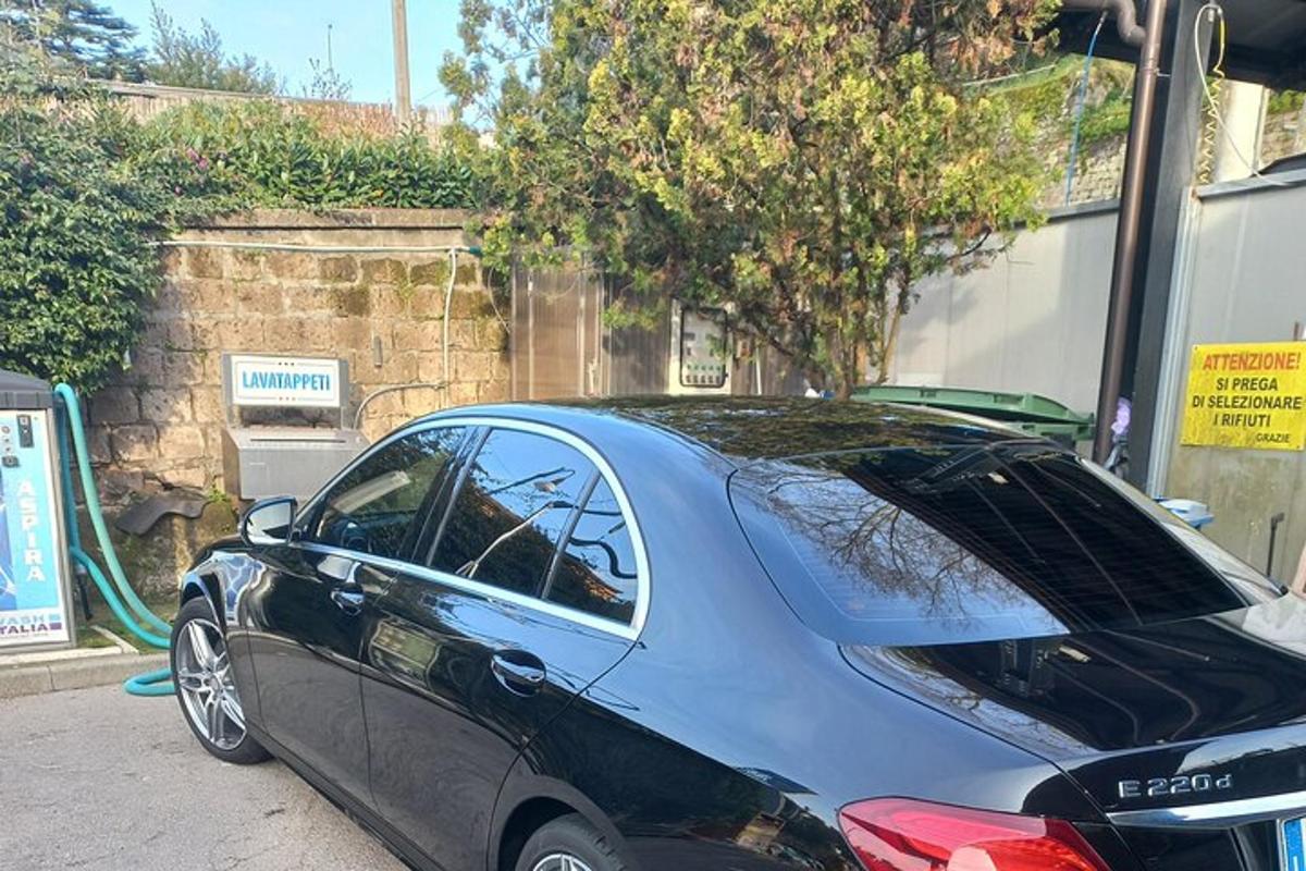 um pequeno carro azul estacionado em um estacionamento