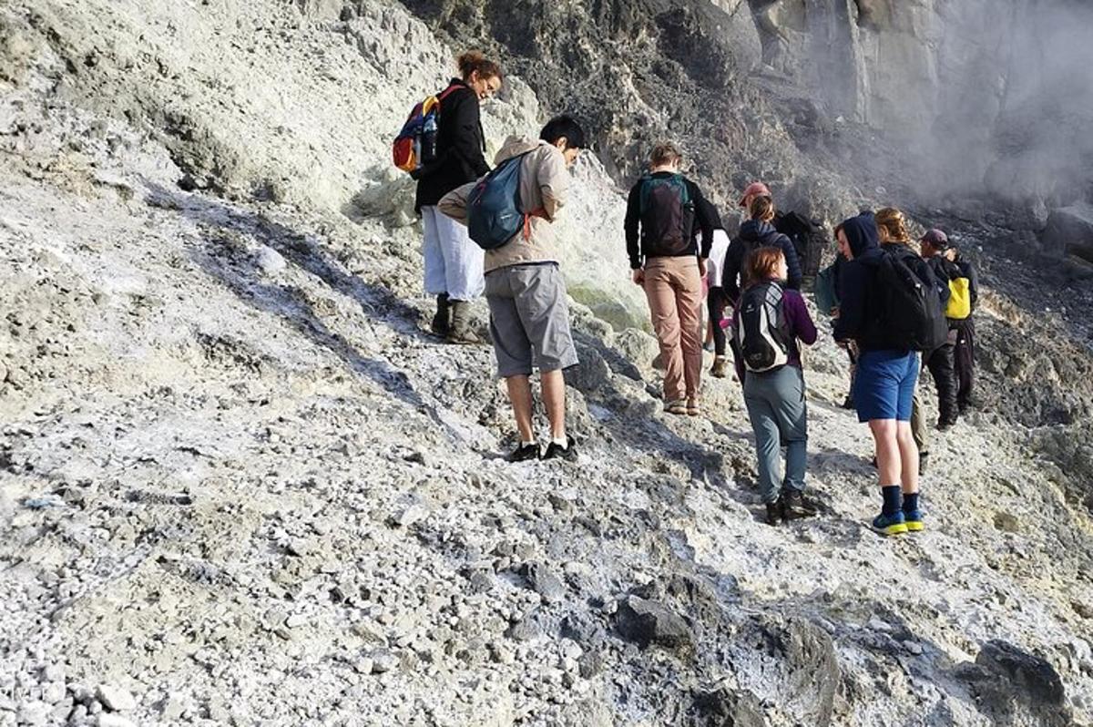 a group of people walking up a rocky mountain