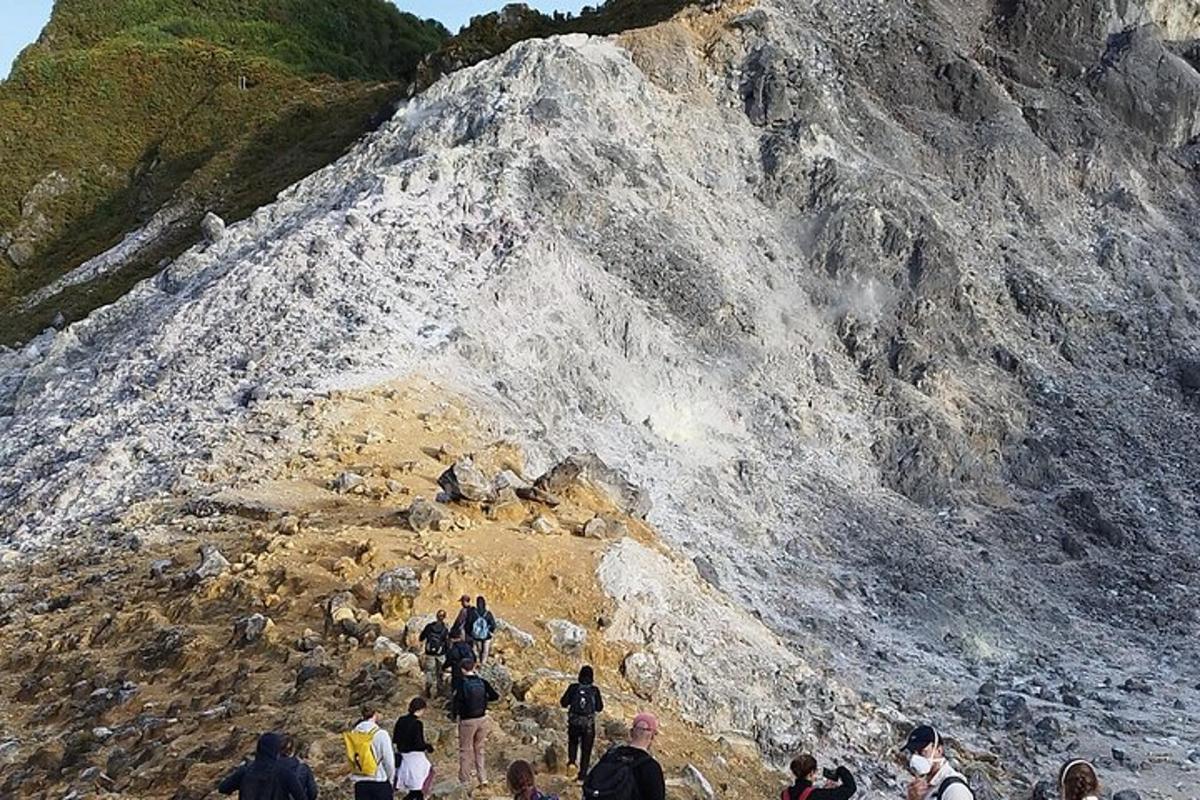 a group of people walking on a rocky mountain
