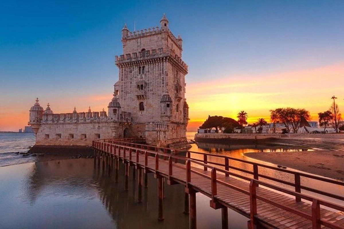 a tower with a bridge in front of the water