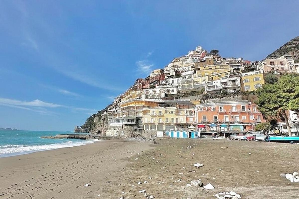 a view of a beach with houses on a hill