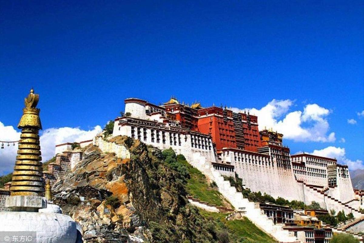 a castle on top of a mountain with a building