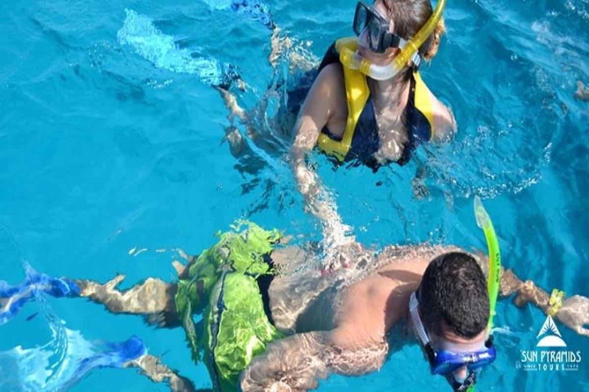 a couple of people in the water with a diver