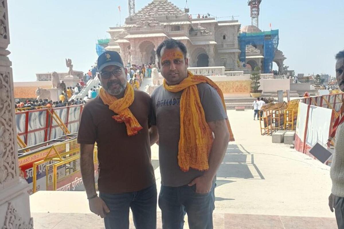 two men are standing in front of a building