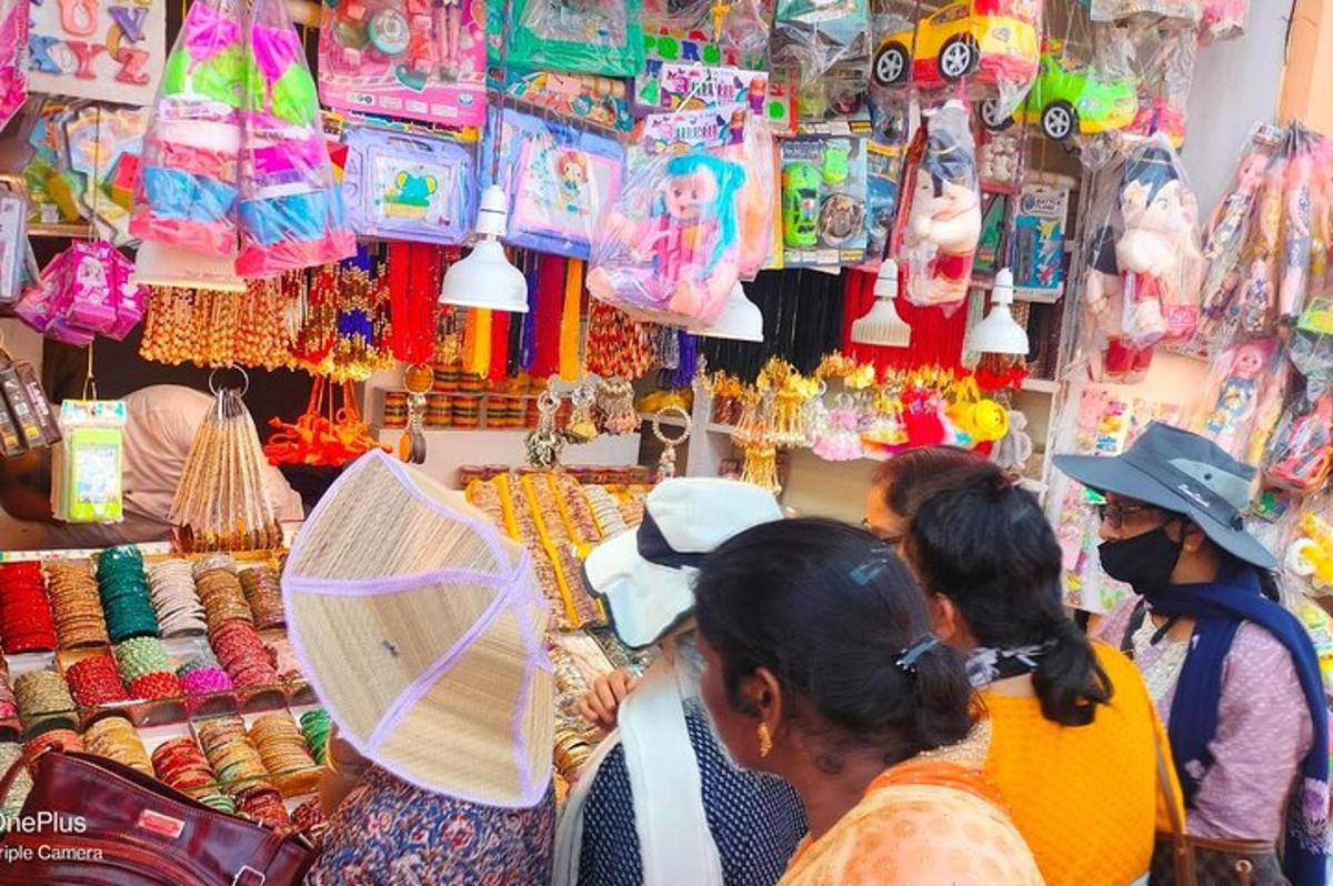 a group of people standing around a store in a market