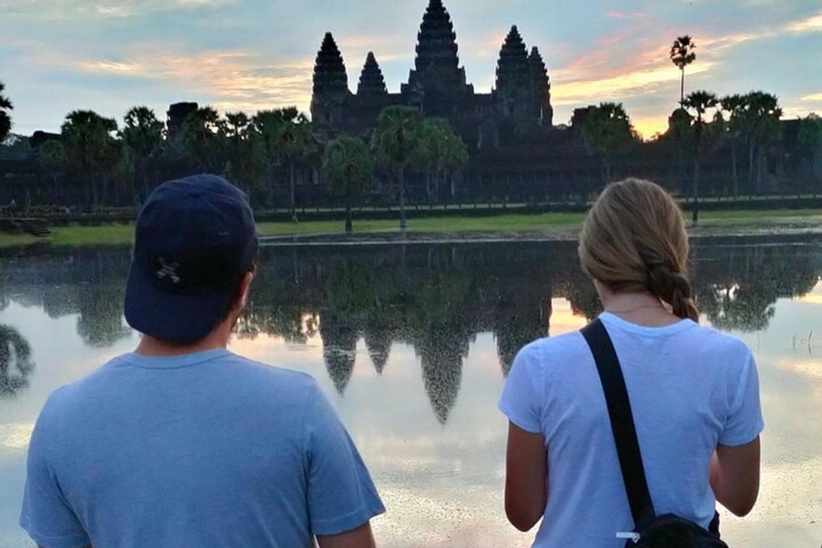seorang lelaki dan seorang wanita berdiri di hadapan kuil