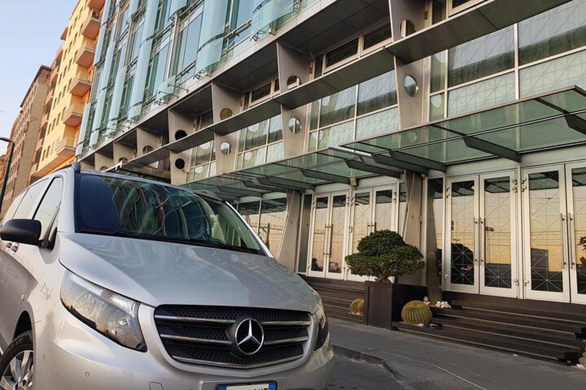 a silver van parked in front of a building
