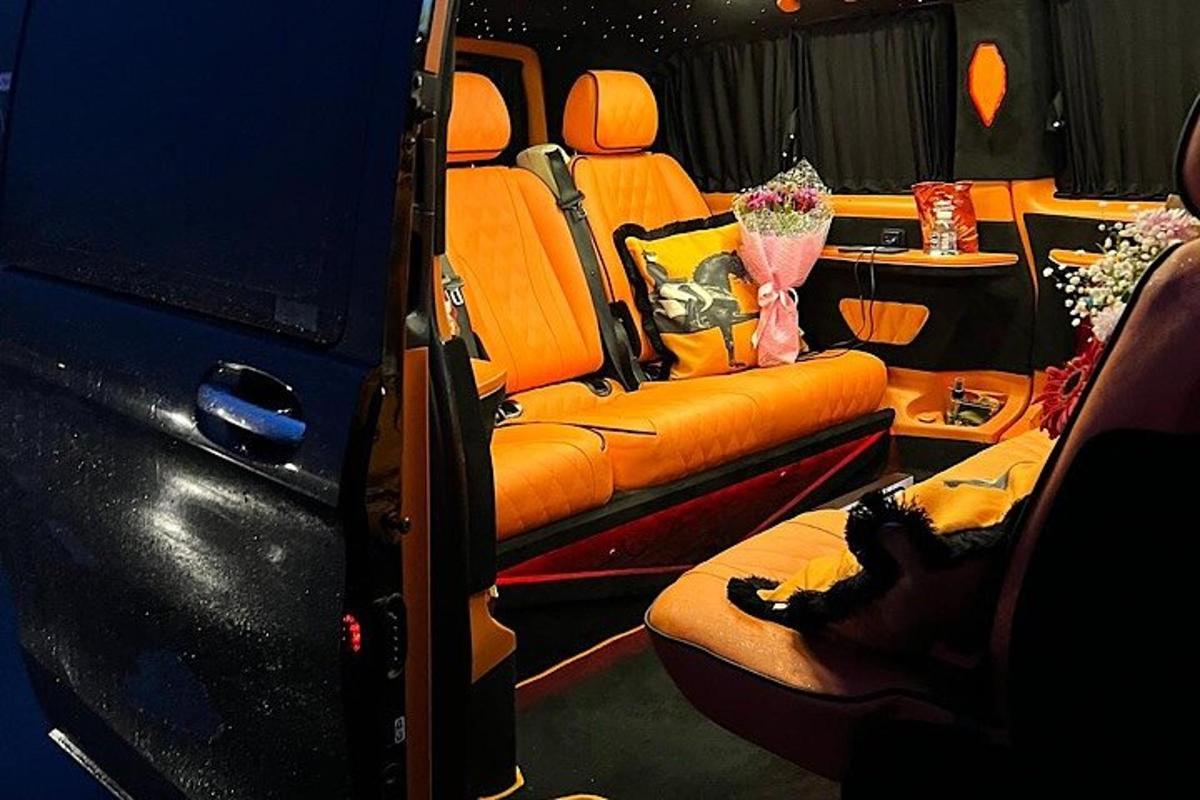 a bus with orange seats and a table with flowers