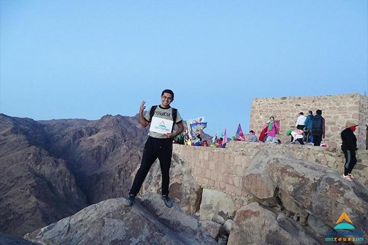 a man standing on the edge of a mountain