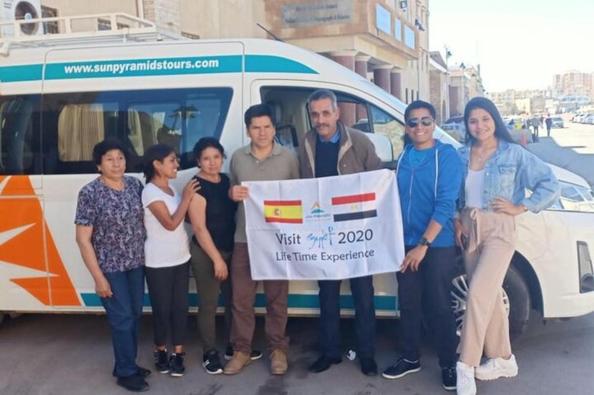 a group of people standing in front of a van