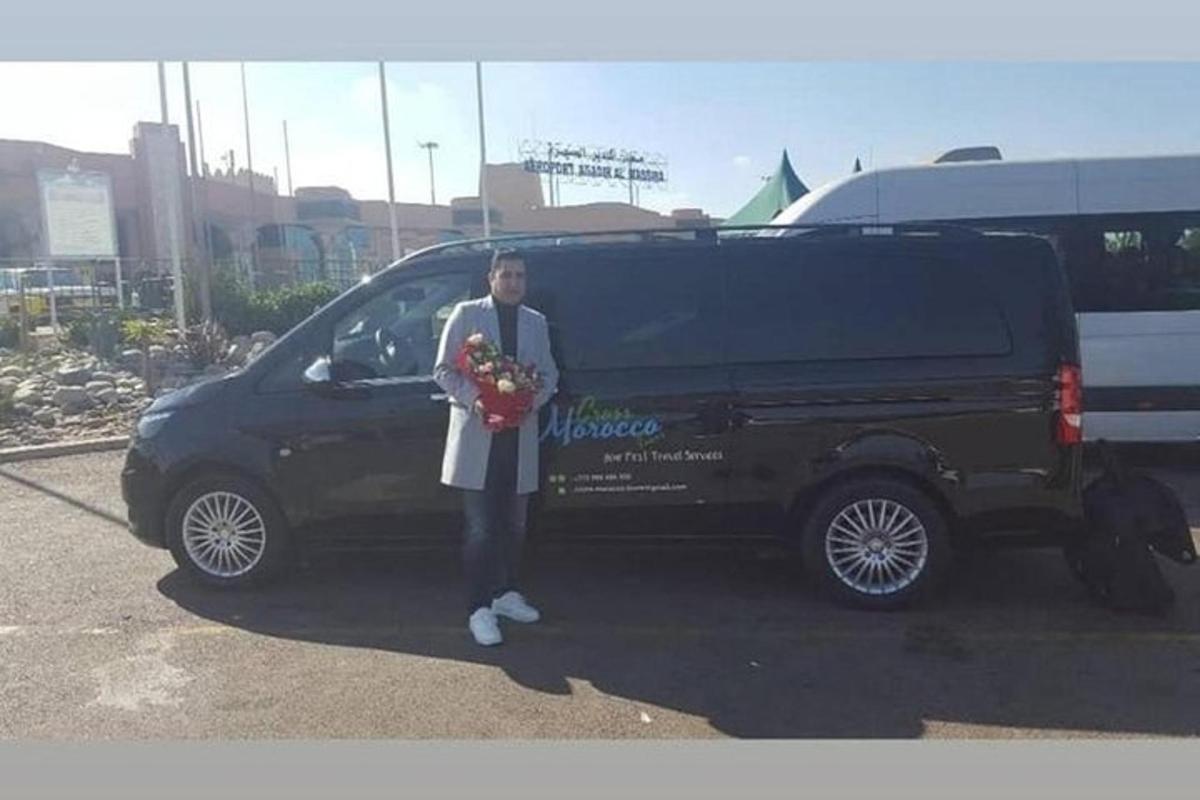 a man is standing in front of a black van