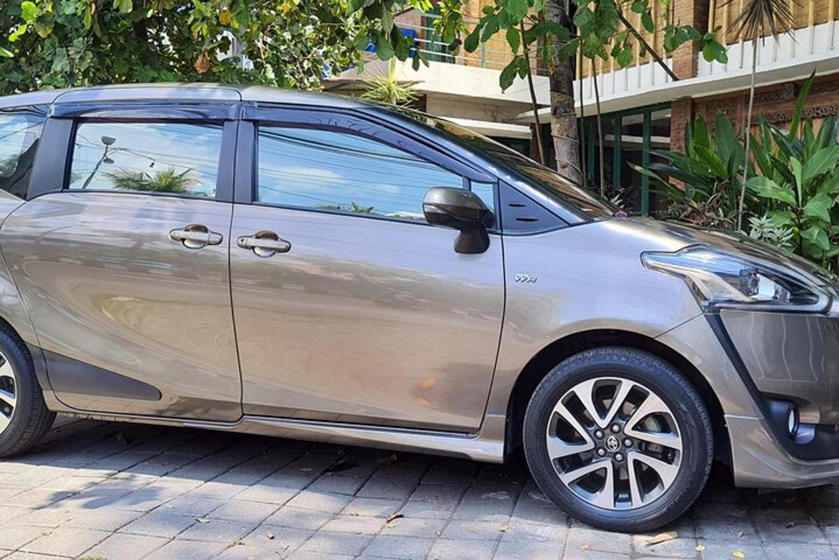 a silver car is parked on a street