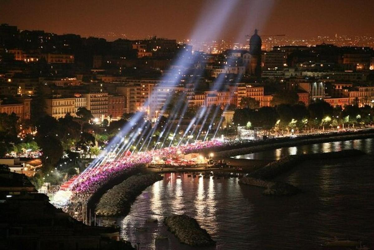 a bridge with lights over a river at night