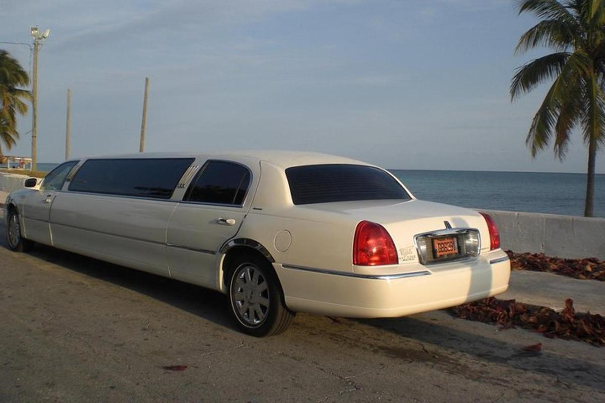 a white car parked on the side of the beach