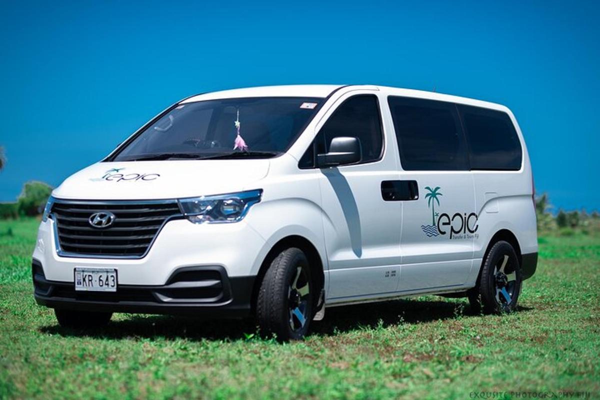 a white van parked in a field of grass