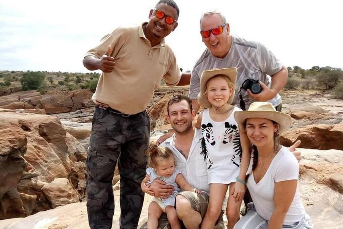 a family posing for a picture on the rocks