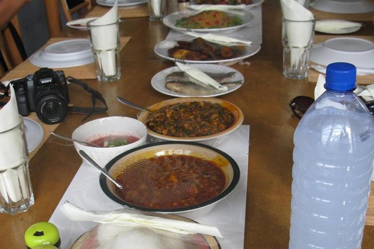 a table with bowls of food and a bottle of water