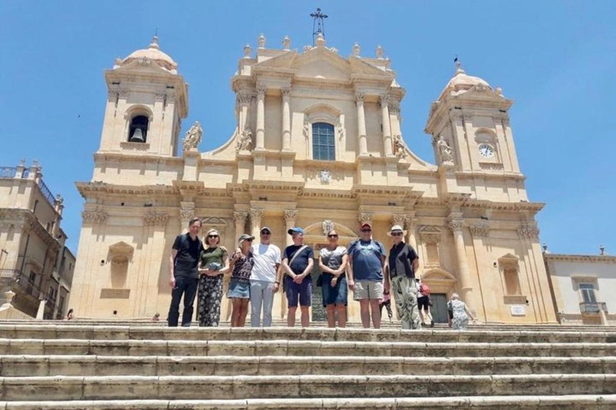 a group of people standing on steps in front of a building