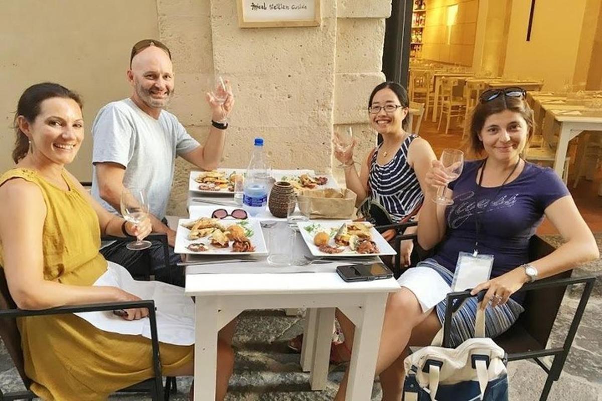 a group of people sitting around a table eating food