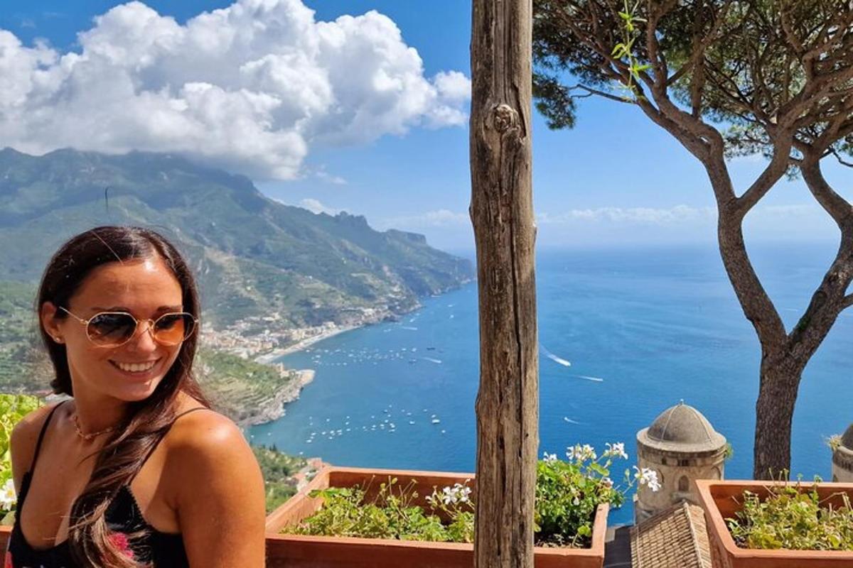 žena stojící na vrcholu kopce a dívající se na oceán