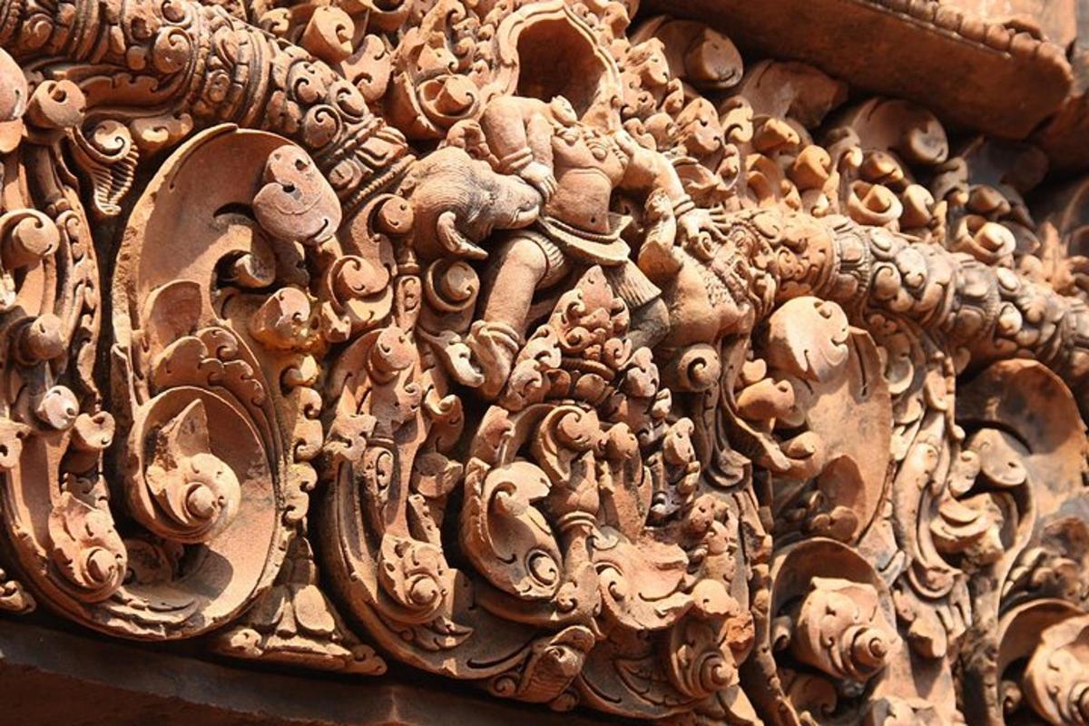 a carving of elephants and animals on a wall