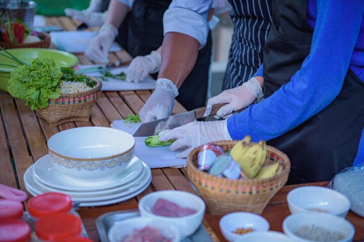 a group of people in gloves preparing food on a table