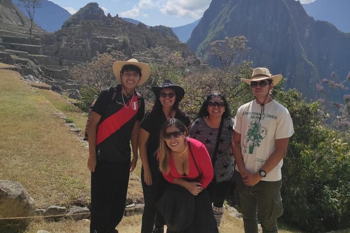 a group of people posing for a picture in the mountains