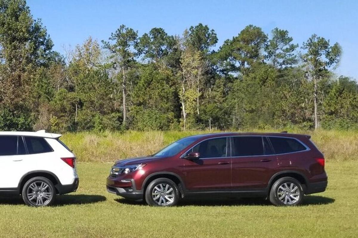 two cars parked next to each other in a field