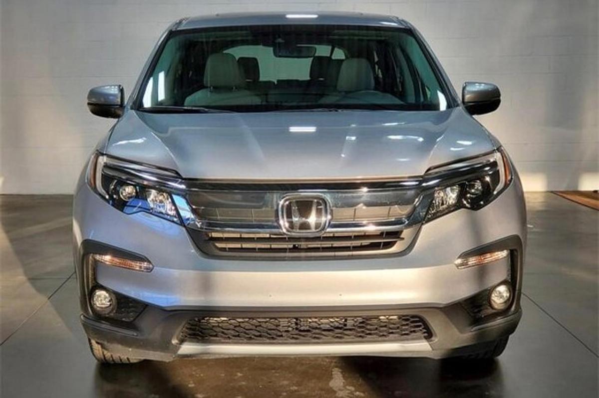 a silver honda odyssey parked in a garage