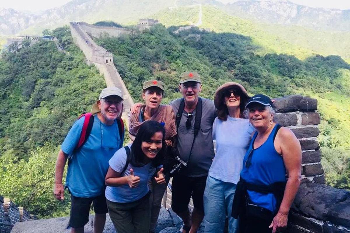a group of people posing for a picture at the great wall