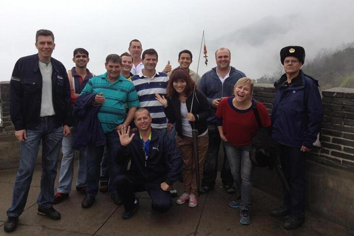 a group of people posing for a picture on a wall