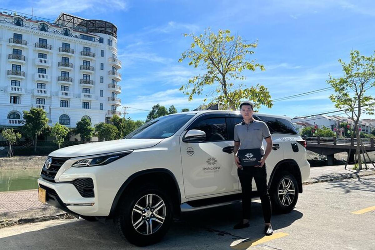 a man is standing next to a white suv
