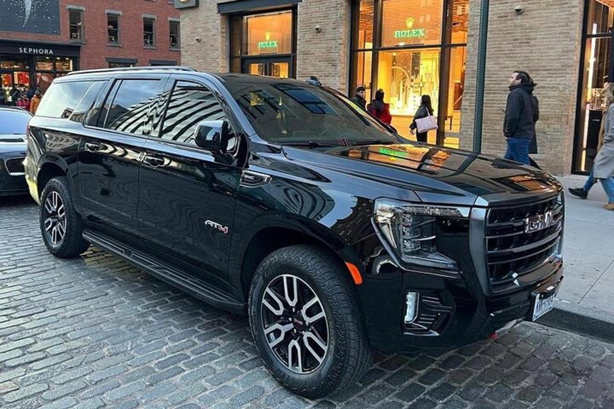 a black suv parked on a city street